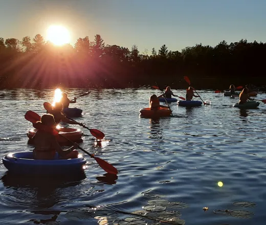 Campers on corcls on lake elaine in the early evening