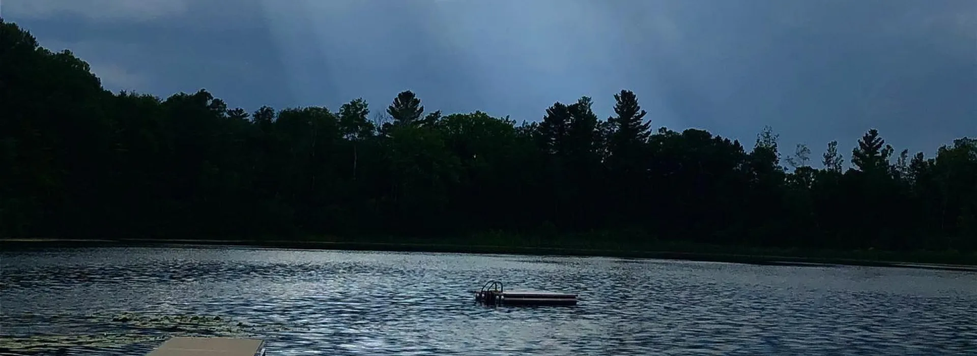 sunrays through the clouds onto lake elaine