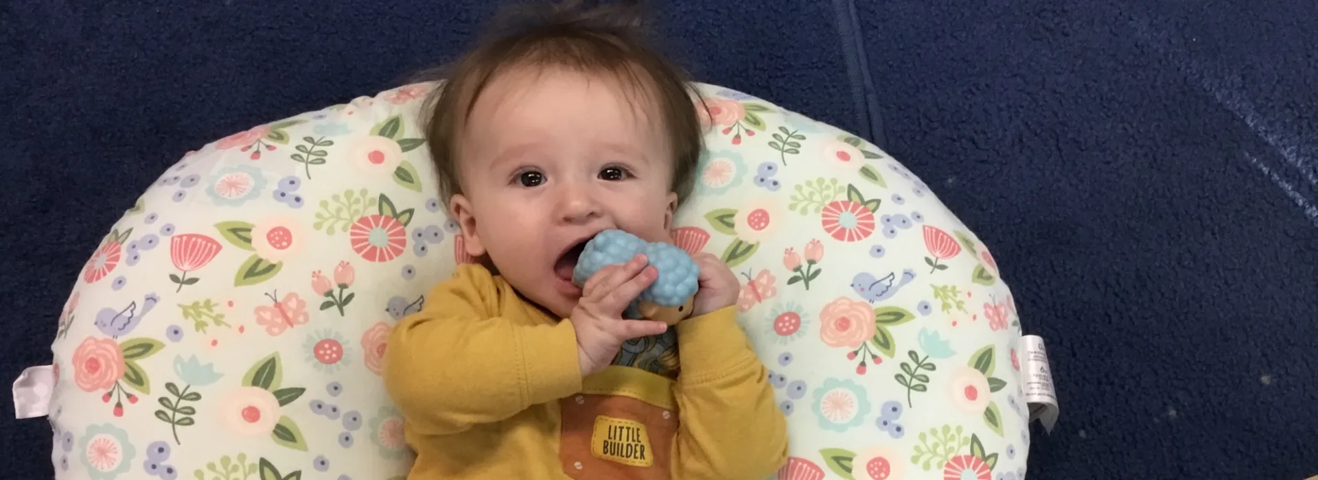 younger child care member enjoying a teething toy