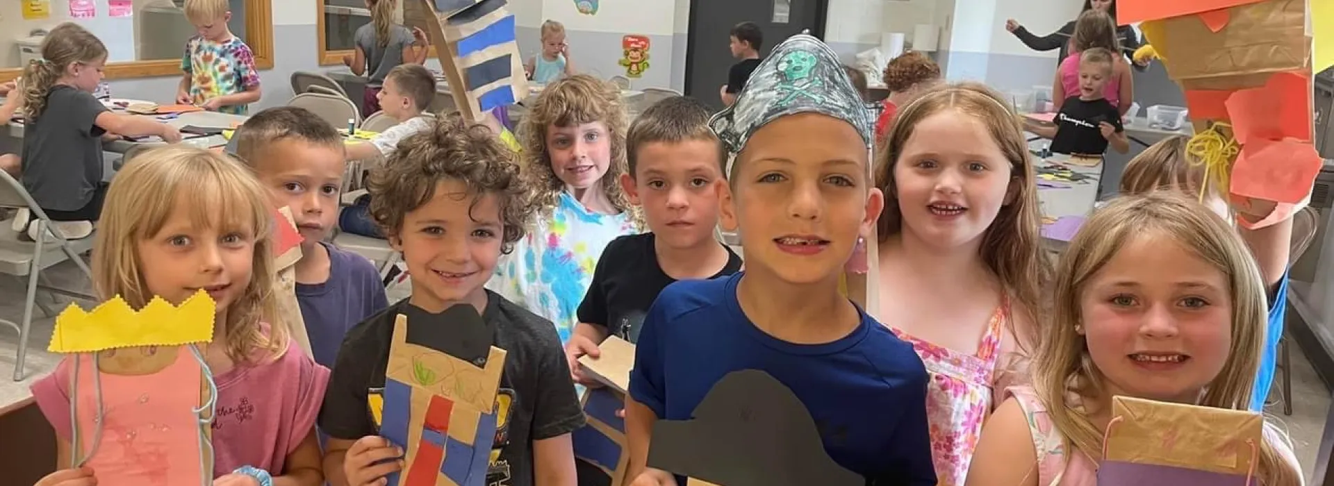 the campers showing off their paper bag puppets